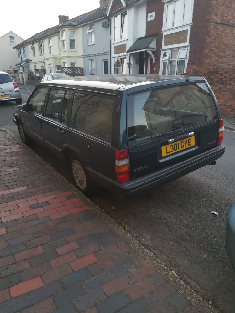 Rear view of a green Volvo estate. 