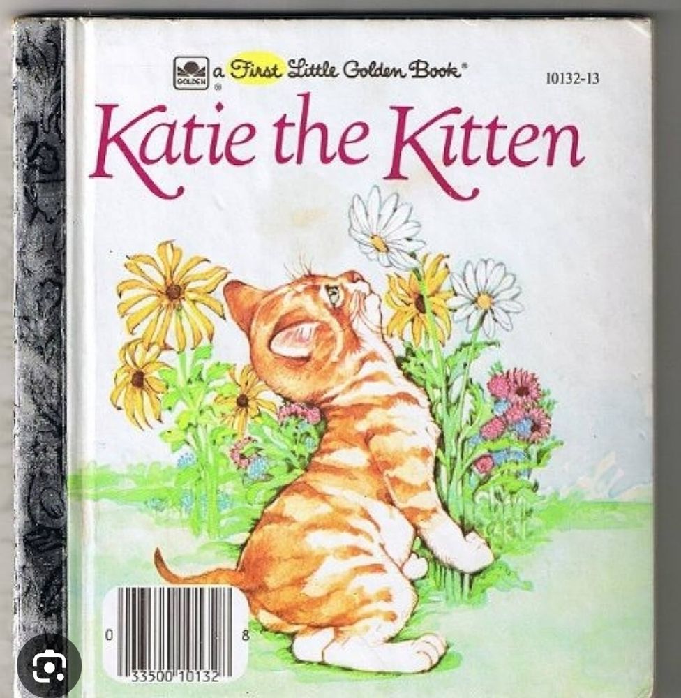 Cover of Katie the Kitten by Kathryn and Byron Jackson, with a cute orange tabby kitten looking up at a daisy. Illustrated by Leslie Morrill.