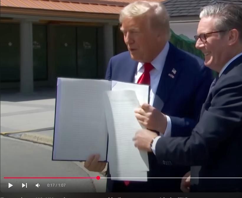 Screenshot from a YouTube video. 
After Trump dropped the “agreement” papers, they put them back together and you can see there is *some* text on them.