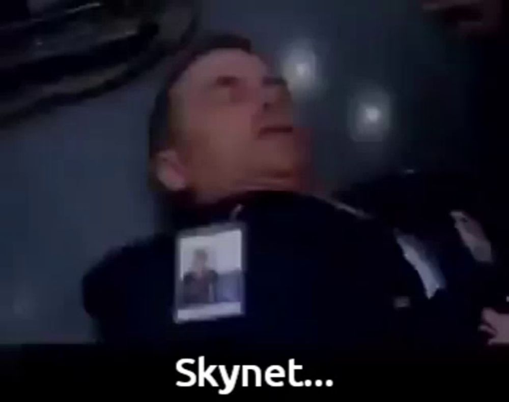 a man in a suit is laying on the floor with the words the virus has infected skynet below him