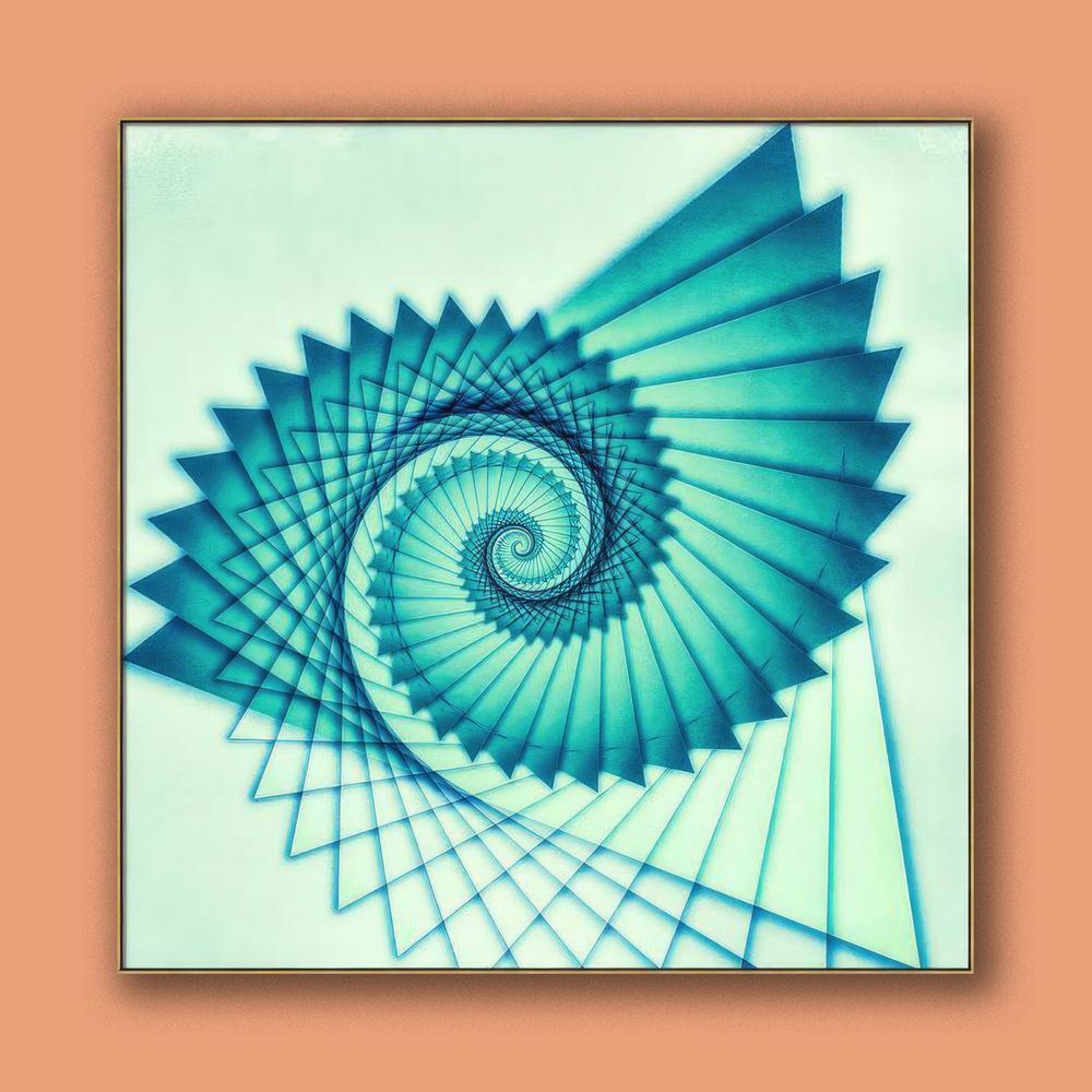This is an abstract artwork shown on a wall against a complementary color background of orange. It is titled Composition de Nautile. A whirl of blue and green hues in a logarithmic spiral evokes the dazzling symmetry of a nautilus shell in this abstract art from contemporary artist/photographer Jon Woodhams.