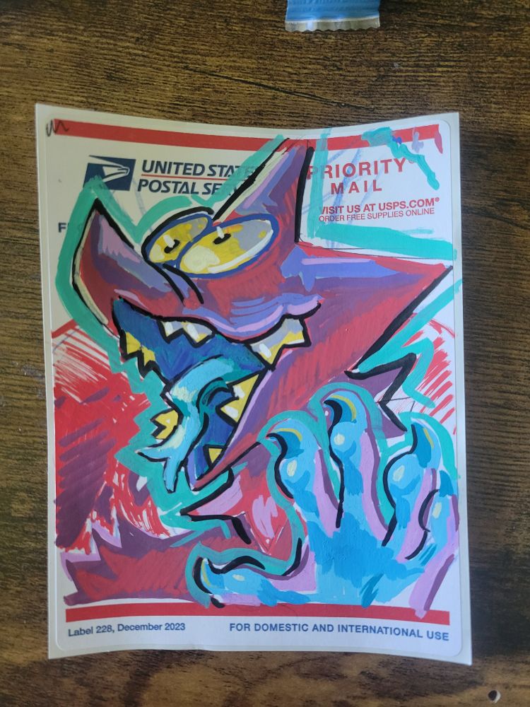 A posca pen illustration of a cartoony dragon on a USPS label