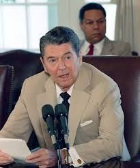 Ronald Reagan wearing a tan colored suit.