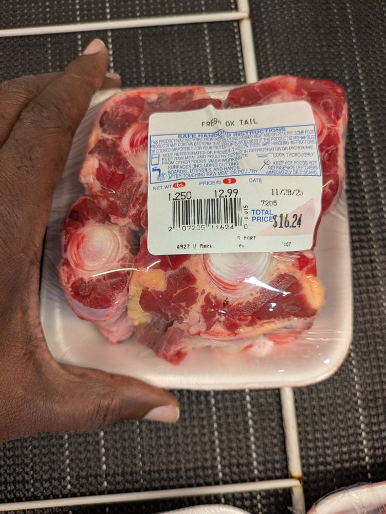 A photo of a package of 4 oxtail bones with a price of $16.24 or $12.99/lb.