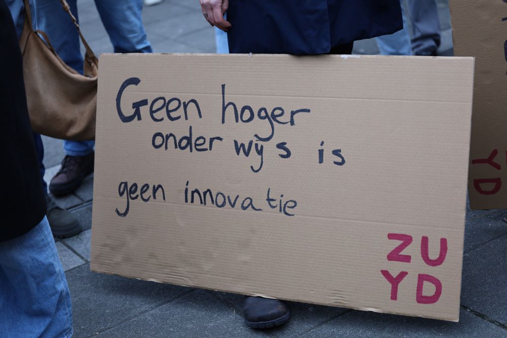 Geen hoger onderwijs is geen innovatie - no higher education means no innovation, a sign with the logo of the Zuyd university of applied sciences is balanced on a protester's foot. 