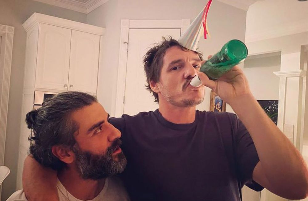 Pedro Pascal with his arm around Oscar Isaac while celebrating New Year’s 