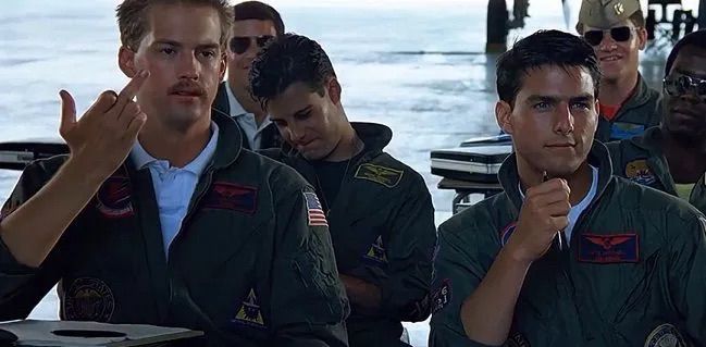 Goose on Top Gun giving the “birdie” to Kelly McGillis’ character.