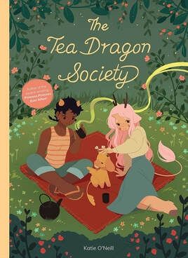 The cover of the Tea Dragon Society, featuring two young people on a picnic blanket surrounded by grass and flowers