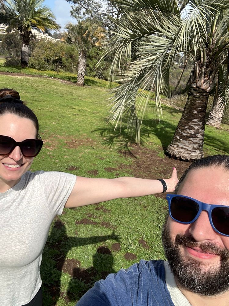 Couple selfie in park with sunshine and palm trees