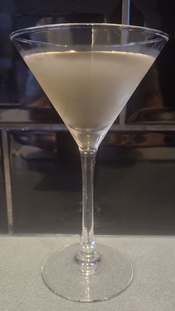 A clear York Special cocktail in a Martini glass.