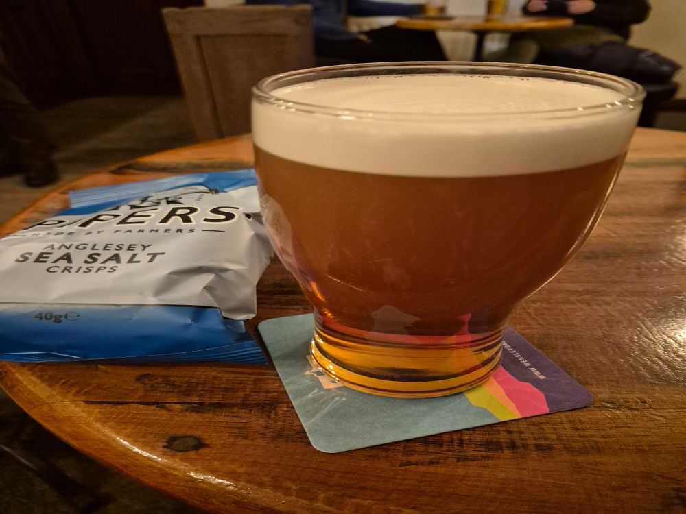 A pint of rocket bitter and a bag  pipers sea salt crisps 