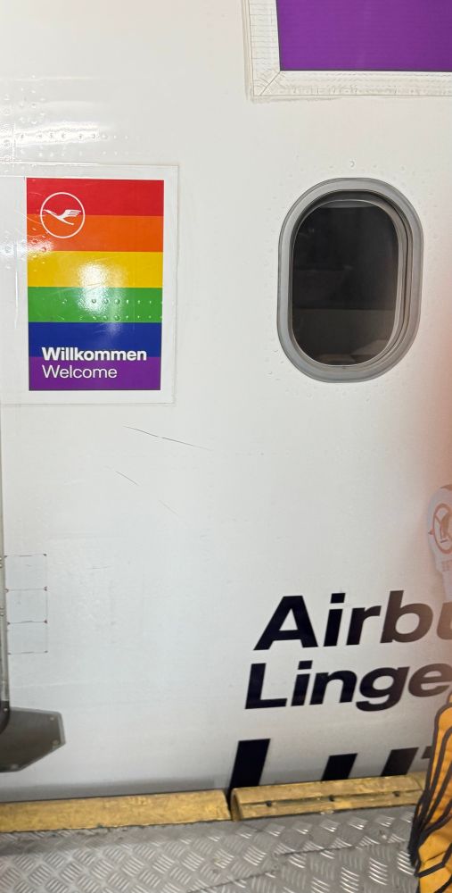 Lufthansa plane with a pride sticker next to the door