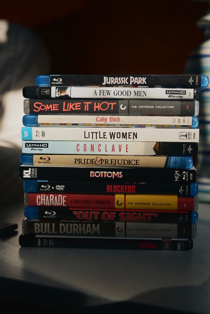 a stack of: 

jurassic park 
a few good men
some like it hot
little women 
lady bird 
conclave 
pride & prejudice 
bottoms 
blockers 
charade
out of sight 
bill durham 
clue 