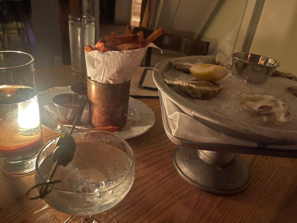 A classy dinner of oysters, fries, and a classic gin martini