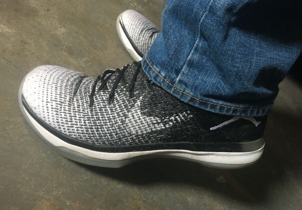 Jordan 31s, with jeans covering the Jumpman logo. 