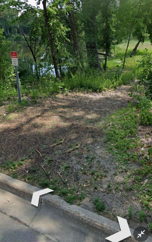 The southwest side of Lake Cornelia has a woodchip path between the lake and private backyards. The land is owned by Edina. This is the view of the earthen path from 66th Street, looking south. 