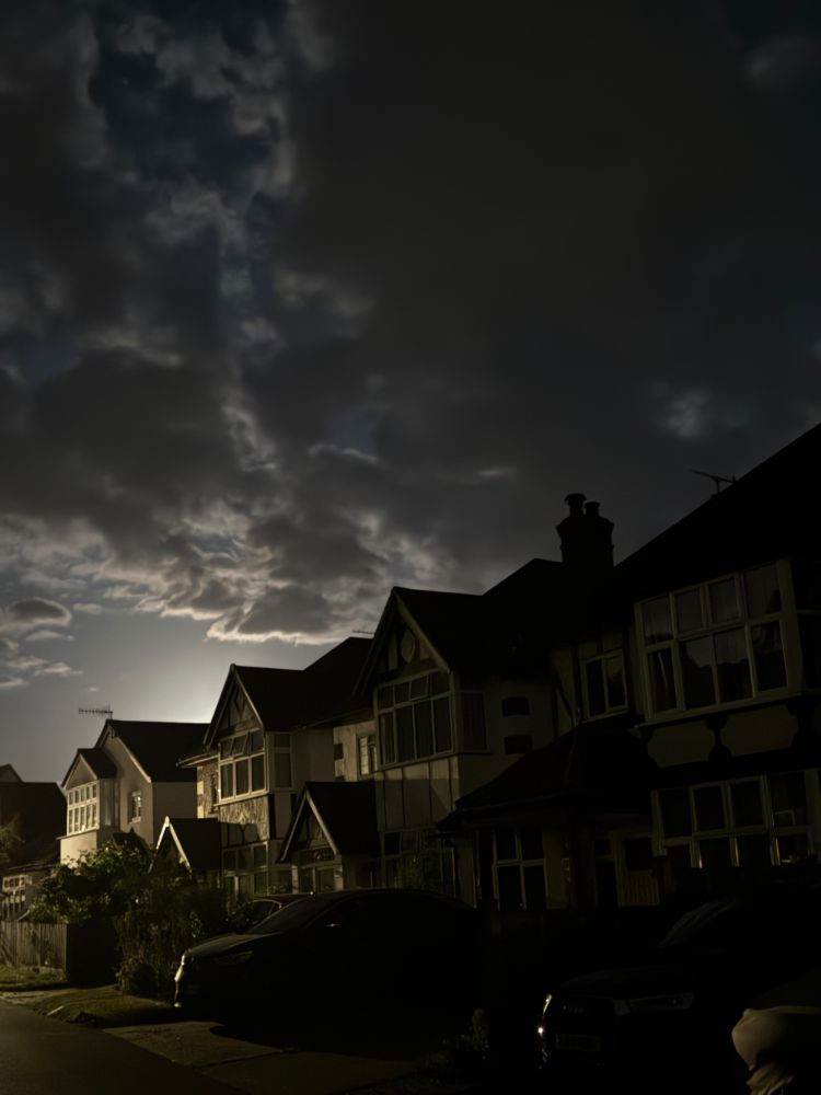 A terraced street of new builds taken at dusk. The angle diminishes the houses in an infinity way.