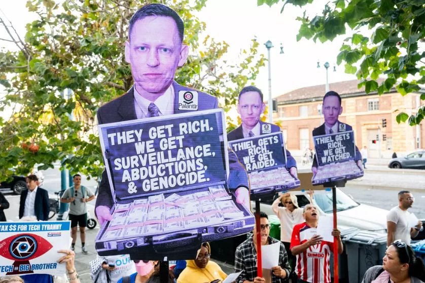 Picture of a protest sign that features Peter Thiel holding a suitcase of money that says "They get rich. We get surveillance, abductions, & genocide" 