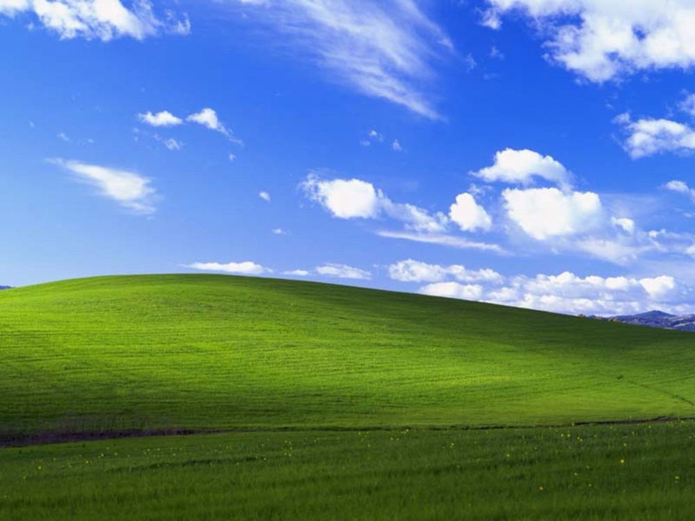 Classic Windows xp wallpaper Showing a blue sky and greens