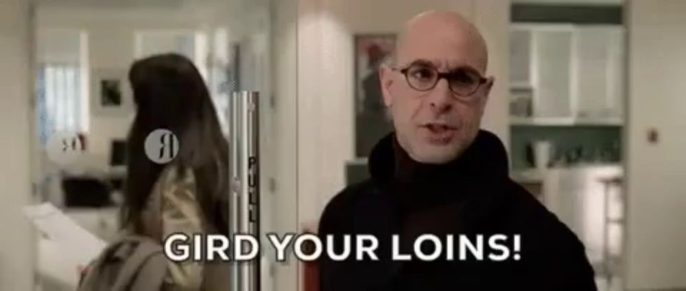 a bald man with glasses is standing in front of a glass door and says `` gird your loins '' .