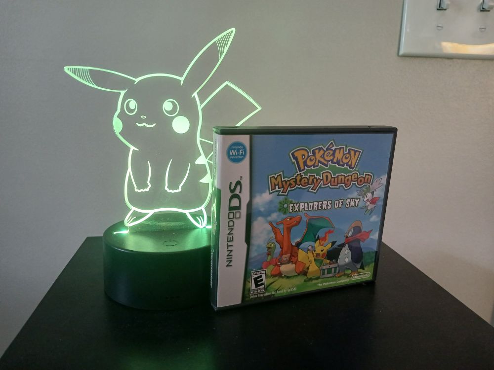 Pokemon Mystery Dungeon: Explorers of Sky next to a Pikachu light