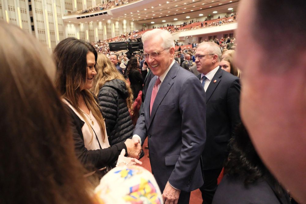 Elder D. Todd Christofferson shakes hands with conference-goers in the Conference Center.