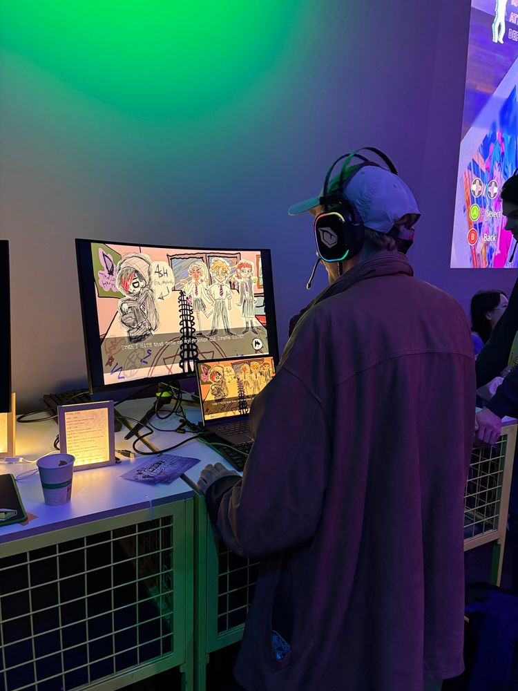 A player plays the game I Write Games Not Tragedies at A Maze Open Screens, 2025