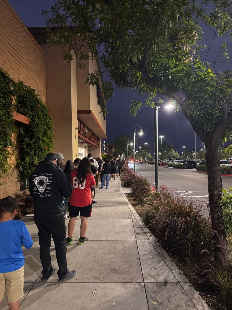 People waiting in line to pick up their Nintendo Switch 2 pre-order at Best Buy.