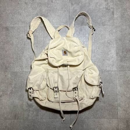 Cream coloured carthartt canvas backpack, many pockets and buckles but will your stuff be safe? 