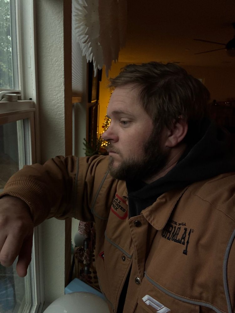 Bearded man staring out the window. 