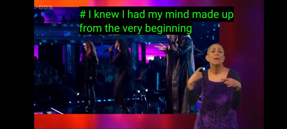 Lady in purple dress dances and signs to a dance on Strictly Come Dancing.