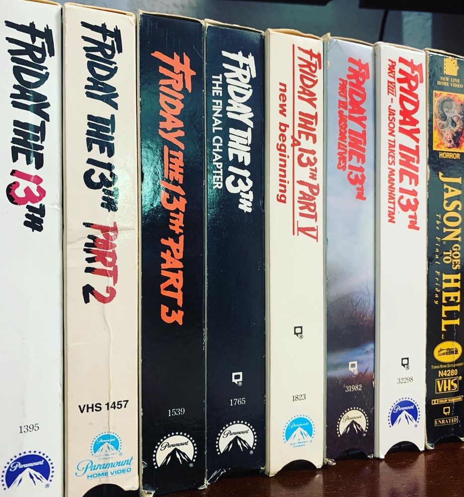 FRIDAY THE 13TH VHS tapes lined up on a shelf, spines facing out.