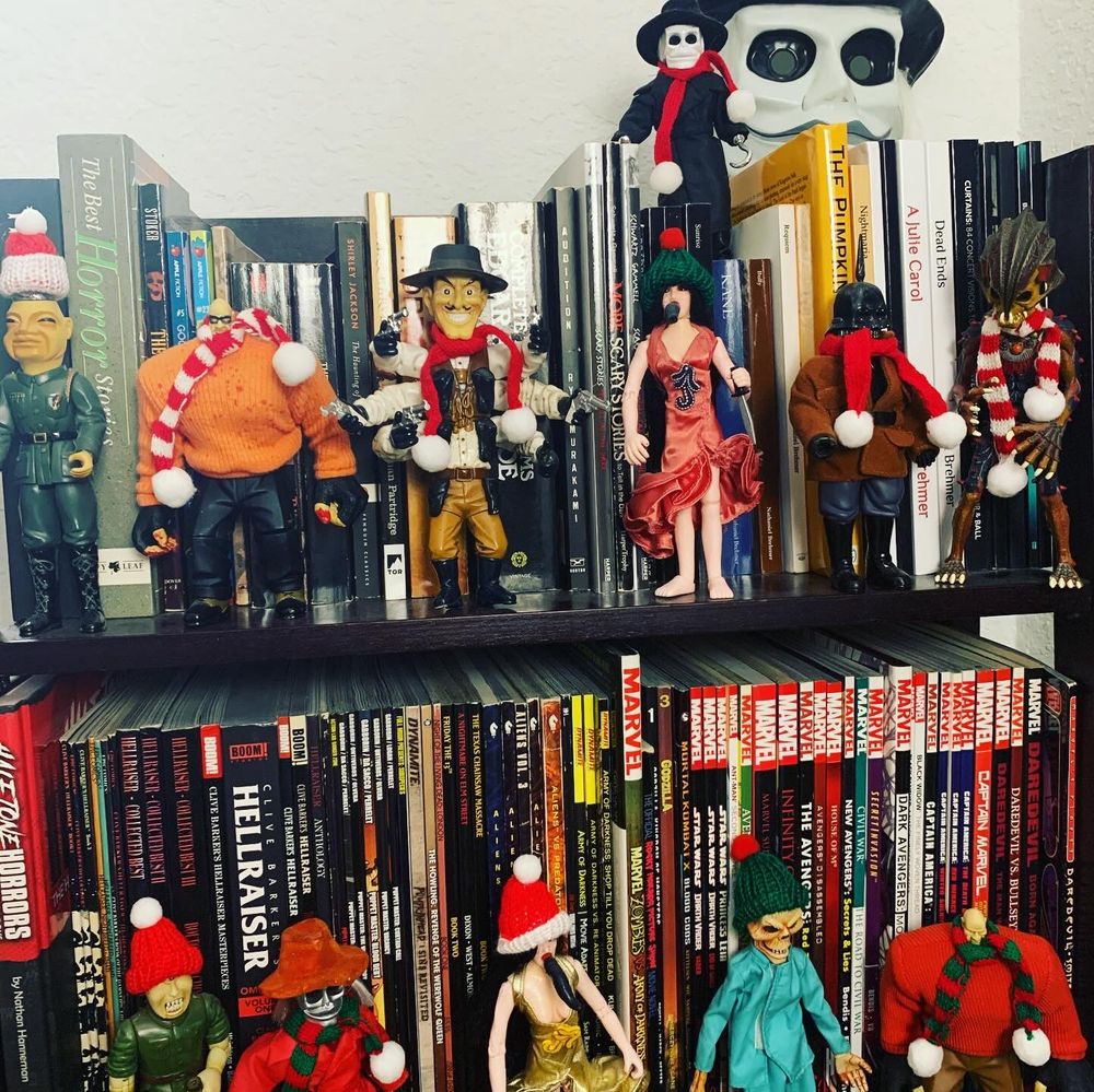 Santa hats and scarves on all the figures on the Puppet Master shelf