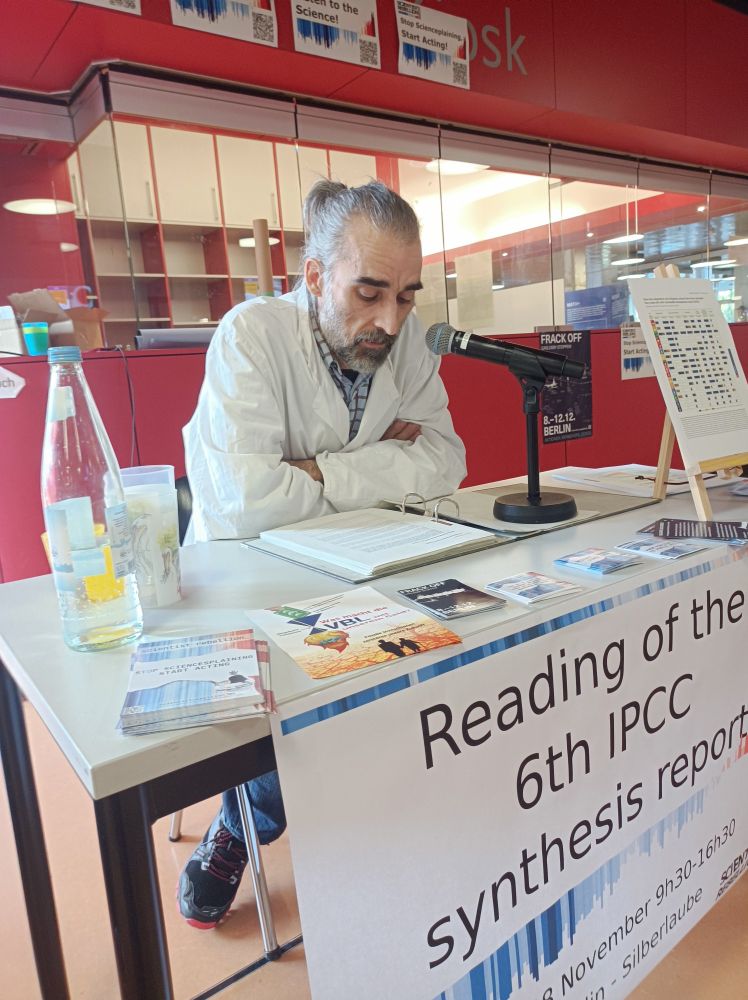 A scientist in a labcoat reading the IPCC report