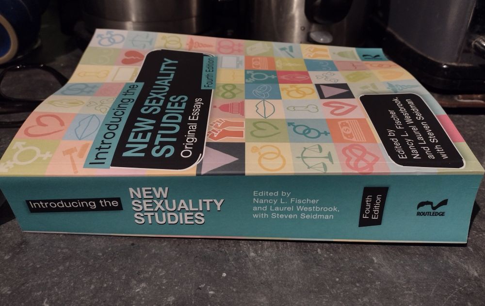 Pic shows the edited volume of Introduction to New Sexuality Studies. Original Essays(4th edition). The side is visible as well as the front cover from an angle, showing that the book is about 4cm thick and alluding (and I can confirm) that it is very very weighty