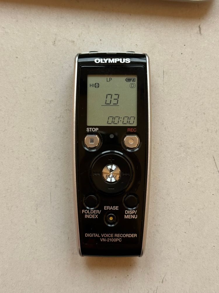 Photo of a black Olympus voice recorder with the screen displaying the number 3