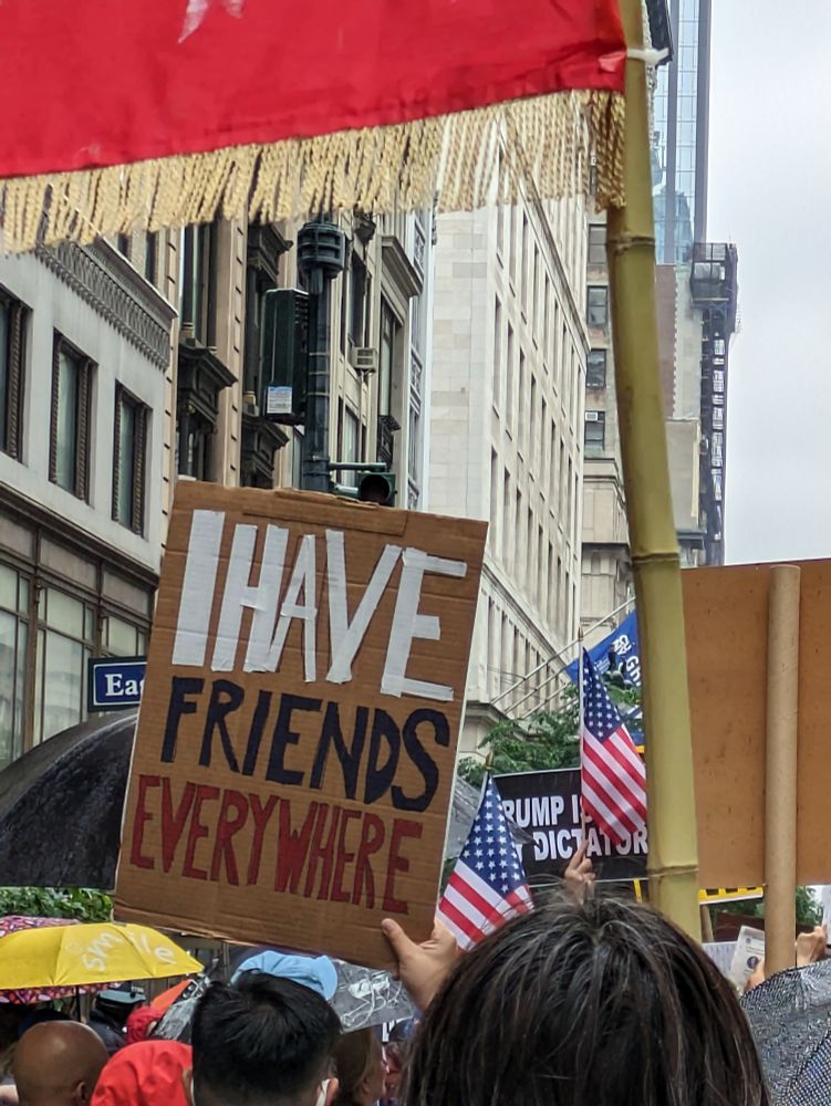 A cardboard sign saying, "I have friends everywhere," which is a reference from andor