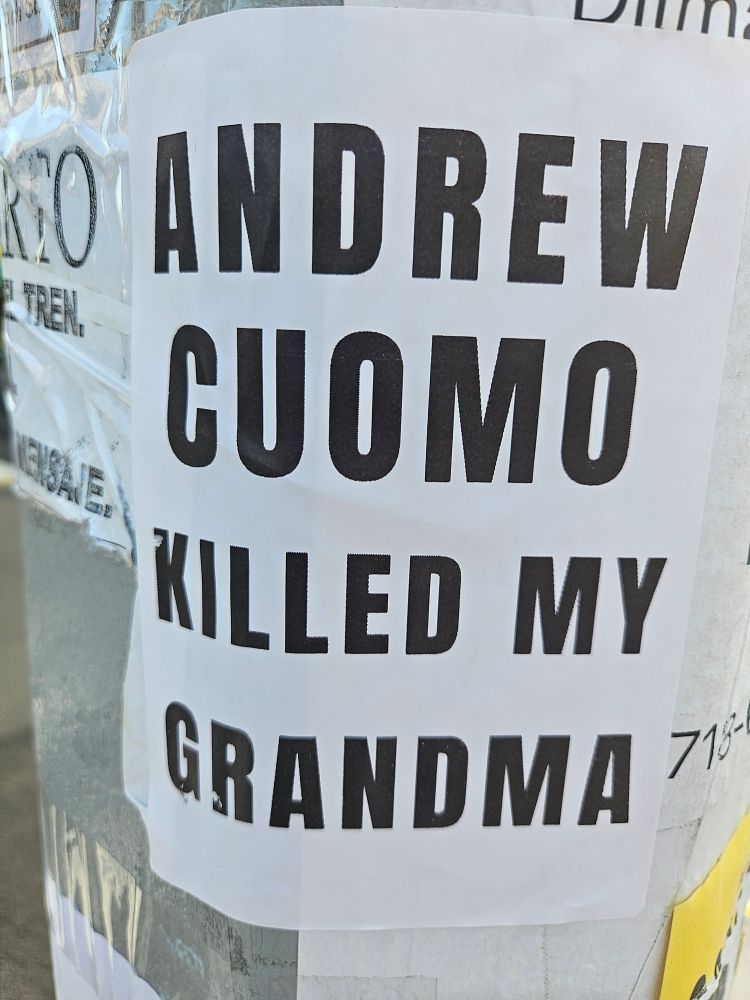 Sign on a post saying Andrew Cuomo killed my grandma