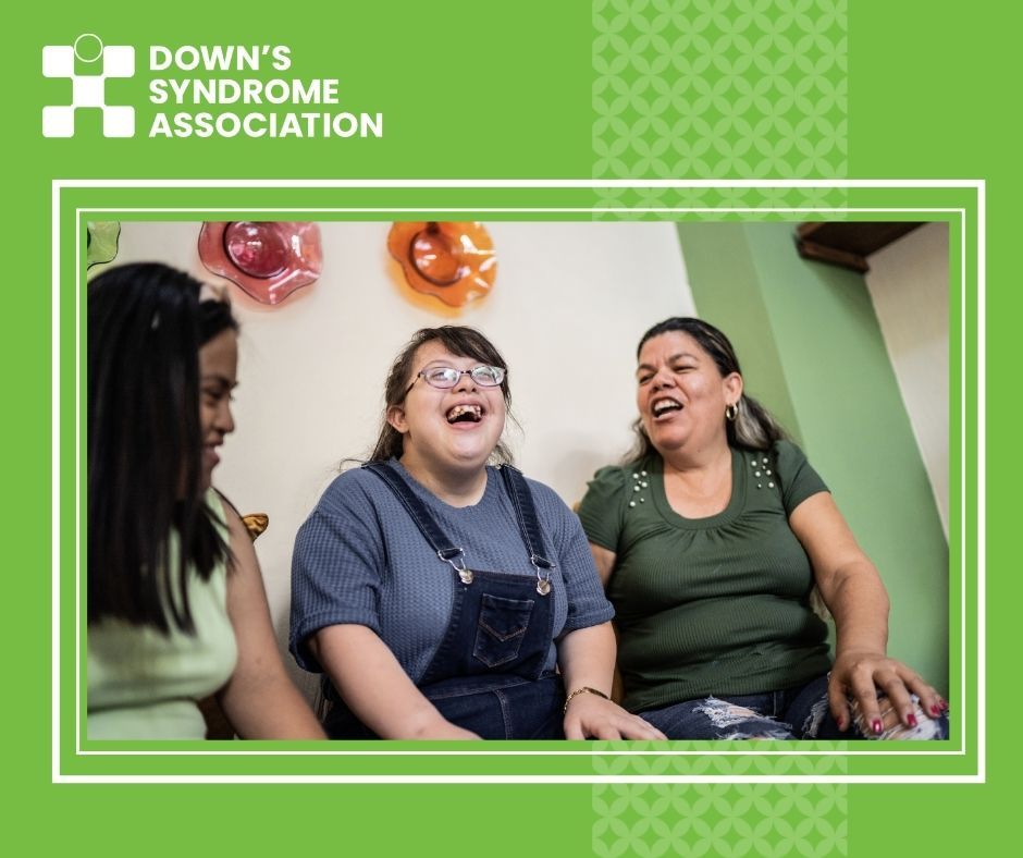 A family of three women are pictured- they are all smiling.