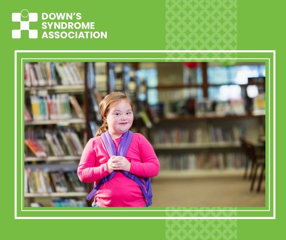 Young girl who has Down's syndrome pictured in school library.