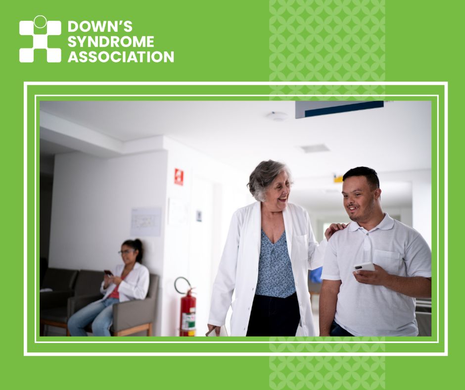 Doctor pictured walking through hospital with man who has Down's syndrome.