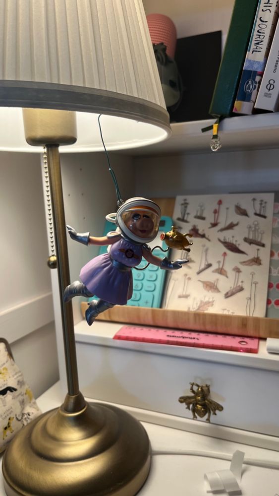 It’s Miss Piggy in her Pigs In Space costume, mid-spacewalk. 