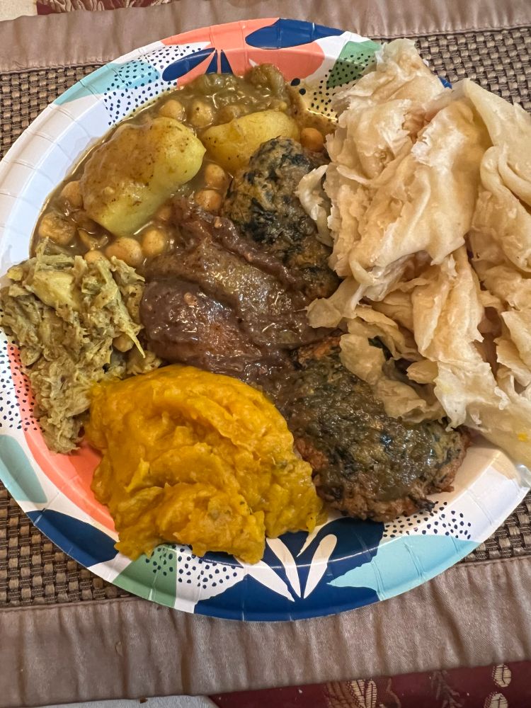 From the bottom clockwise all curries, pumpkin, jackfruit, chickpeas potato, middle is mango and spinach patties and roti on the right