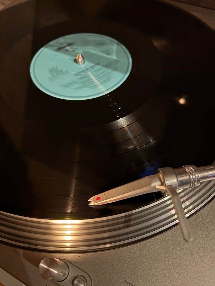 Part of a running turntable playing a very old depeche mode record