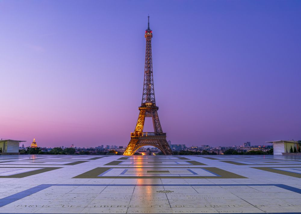 The Eiffel Tower under a pink sky.
