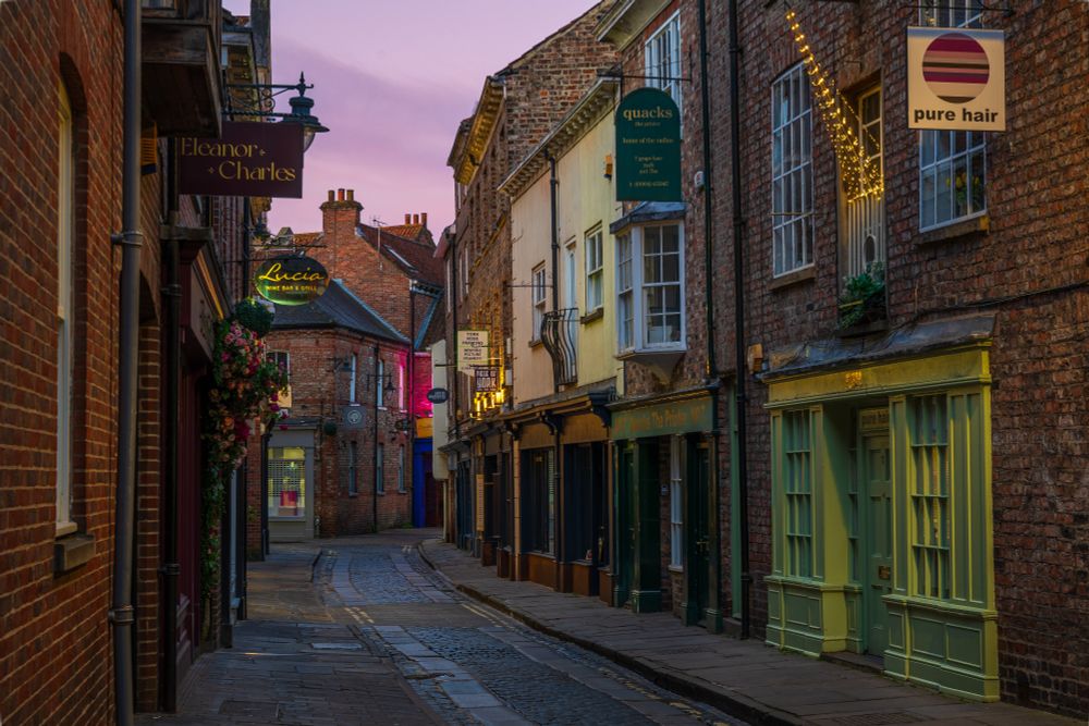 A cobbled street lined with brick buildings.