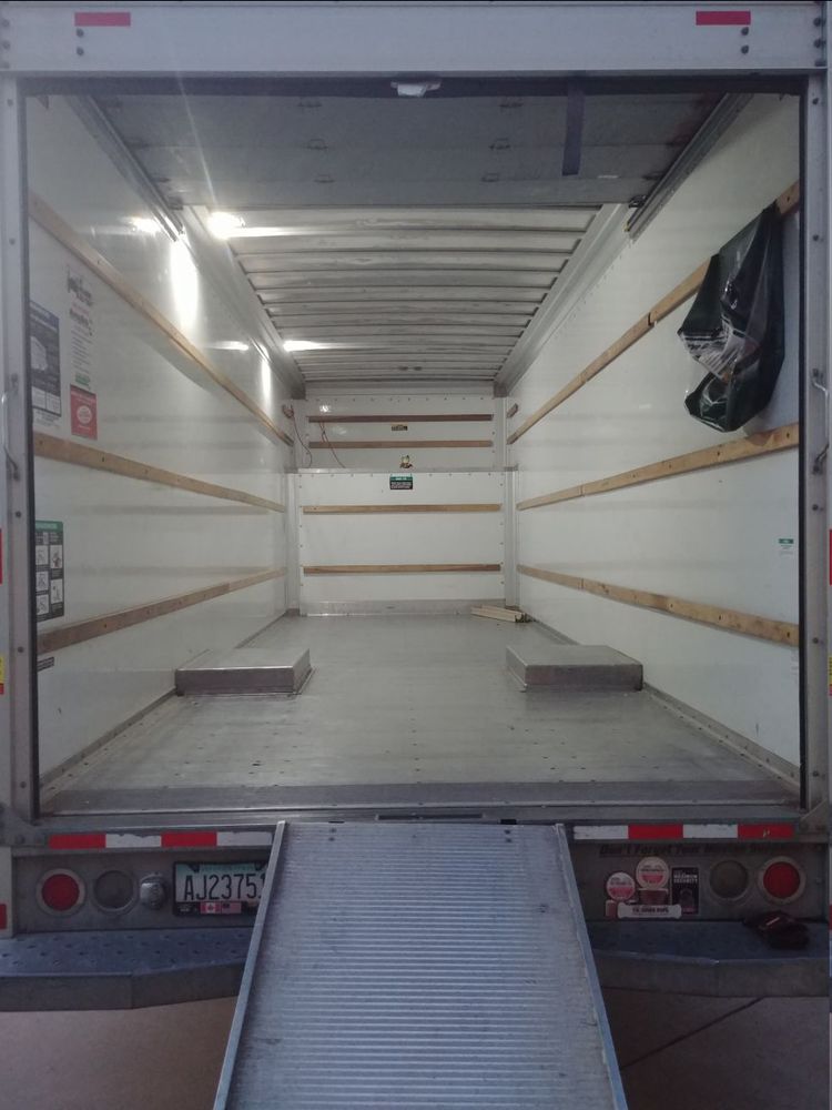 Empty uhaul truck, with a few rope and cardboard pieces. As well as Girl_DM_ nui in the center at the edge of the attic area.