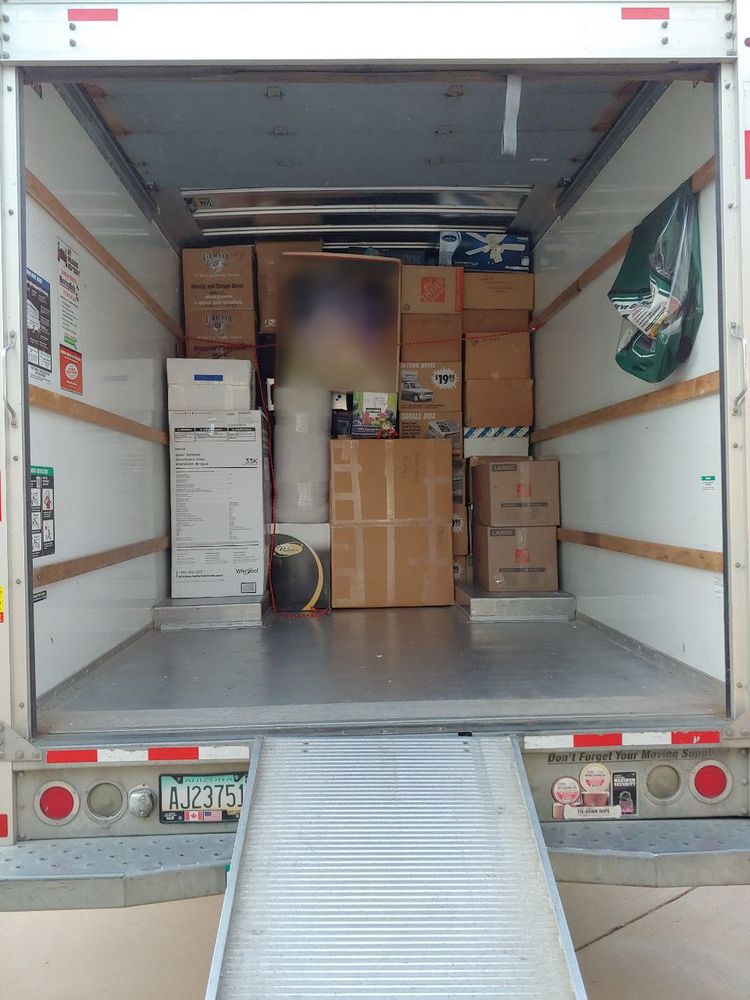Boxes from floor to ceiling at the wheel well of the truck. Girl_DM_ nui on center box.