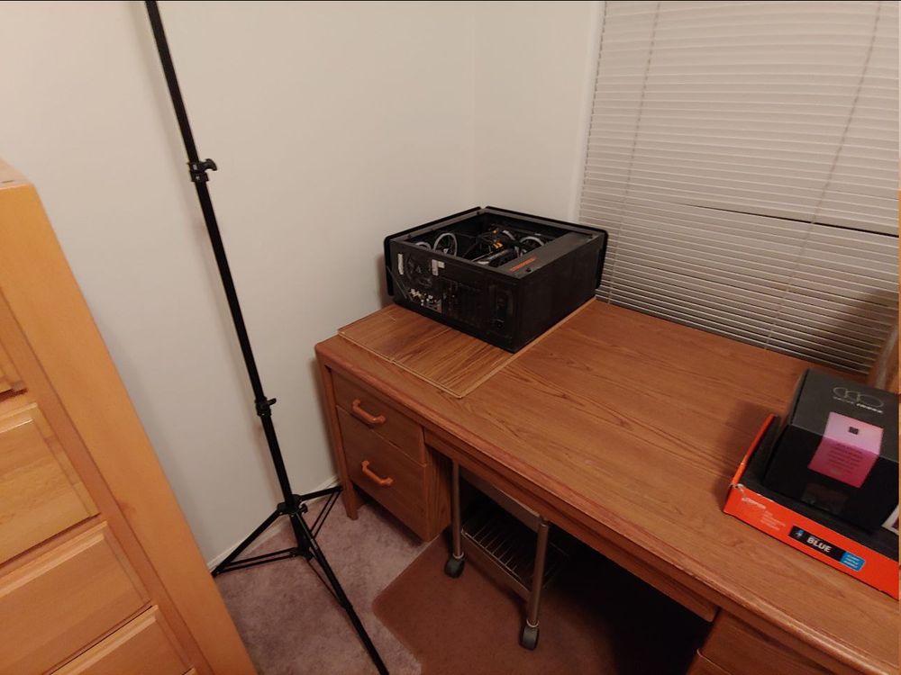 Desktop on its side, on boards, on the edge of a desk, in the corner of the room.