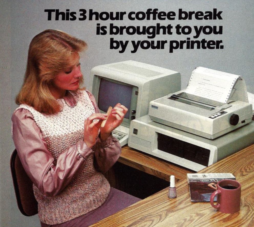 Ad for a print buffer (early personal computers couldn't be used while they were printing), with a woman sitting at the desk doing her nails and drinking coffee. Headline reads, "This 3 hour coffee break is brought to you by your printer."